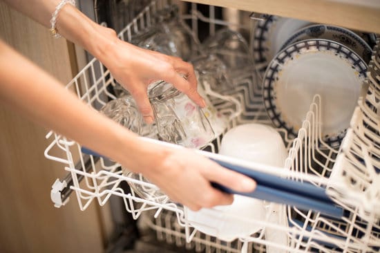 How to get rid of the white residue or film on the dishwasher?